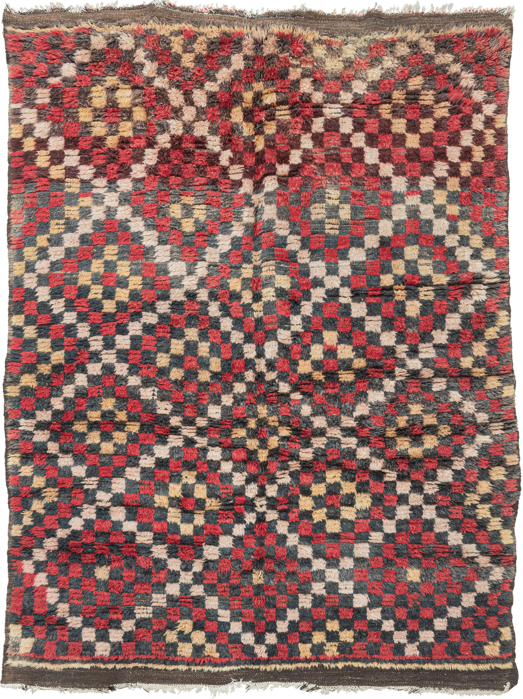 This Geometric Turkish Tulu  features a pattern of intersecting concentric diamonds formed of various squares in red, black, yellow and ivory. Coarsely rendered in shaggy wool creating a plush pile.   In good condition, with uneven fading and wear near the ends. Pile is thick and shaggy, with a soft handle. 