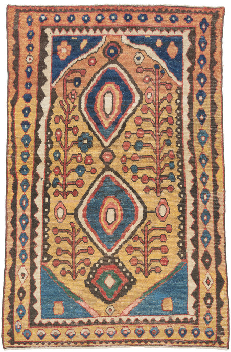 This vibrant Gabbeh was woven by the Qashqai during the 2nd quarter of the 20th century

The design centers on bold concentric diamond medallions floating on a warm saffron field. The medallions are flanked by playful flowering shrubs and framed by a charming rosette border. The palette is exceptional: saturated indigo, terracotta, sky blue, and emerald green, all rendered in luminous natural dyes.