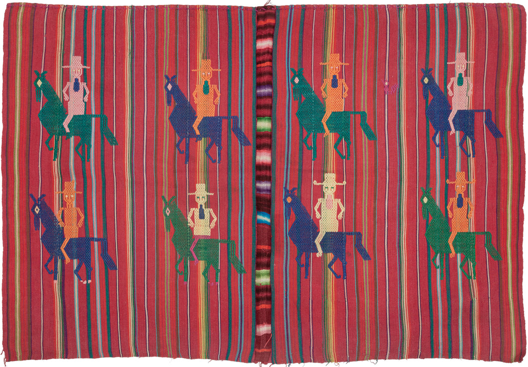 A festive Guatemalan tzute, vividly woven with striped ground in red, green, and purple tones. The textile is enlivened by repeated brocaded figures of horse and rider, depicted in bright contrasting colors of yellow, green, blue, pink, and orange each wearing a wide-brimmed hat and rendered in a bold, geometric style.