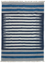 19th century Indian Jail dhurrie featuring a series rows of deep navy and bright white stripes which feather at each end in the central panel. Two skirt panels feature smaller alternating white and navy stripes broken up by two bright indigo blocks. These rugs were part of prison reform beginning in 19th century India.