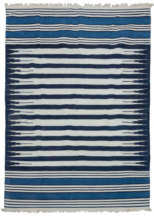 19th century Indian Jail dhurrie featuring a series rows of deep navy and bright white stripes which feather at each end in the central panel. Two skirt panels feature smaller alternating white and navy stripes broken up by two bright indigo blocks. These rugs were part of prison reform beginning in 19th century India.