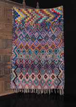 Vintage Moroccan Boucherouite rug with multicolor diamond design. braided fringe on one end. in excellent condition