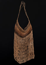 Vintage sedge grass dilly bag from Australia.   This bag employs a continuous loop to create the structure. The material used is dried sedge grass, dyed in various shades of brown.  In very good condition, signs of wear consistent with age. Very light and airy handle. 