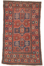 Antique 19th century Kazak rug featuring three navy medallions, on a red ground with a variety of neatly organized protection symbols. But the wide main border composed of large blossoming rosettes on candy cane stems steals the show. In a hard-to-find format for type.