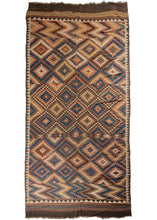 Antique Afghan Maimane kilim composed of a stepped-diamond pattern in light and dark blues, reds, browns, ivory, yellow, and orange. Multiple times the diamond pattern breaks and reforms into different variations of itself. Zig-zag sections reminiscent of lightning bolts add some electricity to each end and the whole is framed by a perimeter of reciprocating brown and white and brown triangles. The whole is finished with simple striped skirt kilim on either end.