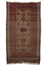 Antique Baluch scatter rug featuring madder red and aubergine dyed wool playinng nicely with soothing camel and oxidized browns, while a pop of indigo shines dead center and makes another appearance in the intact kilim edge. Both the warp and weft are constructed out of handspun wool. 