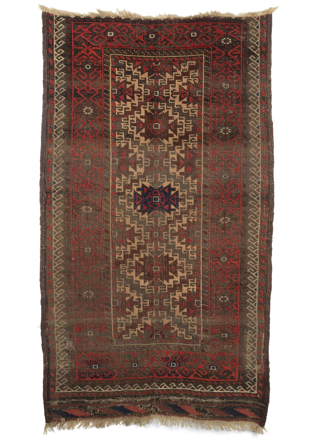 Antique Baluch scatter rug featuring madder red and aubergine dyed wool playinng nicely with soothing camel and oxidized browns, while a pop of indigo shines dead center and makes another appearance in the intact kilim edge. Both the warp and weft are constructed out of handspun wool. 