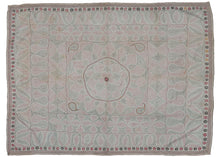Antique large Kantha featuring a central floral sun-like mandala flanked by paisley or "Kalka" forms in each cornice. It has a limited palette of various red and black threads on a plain white cotton ground which is subtle but intriguing. Fine stitching and whimsical movement play well with the large scale and use of negative space. Perfectly framed by thin pinwheel and arrowhead borders. 