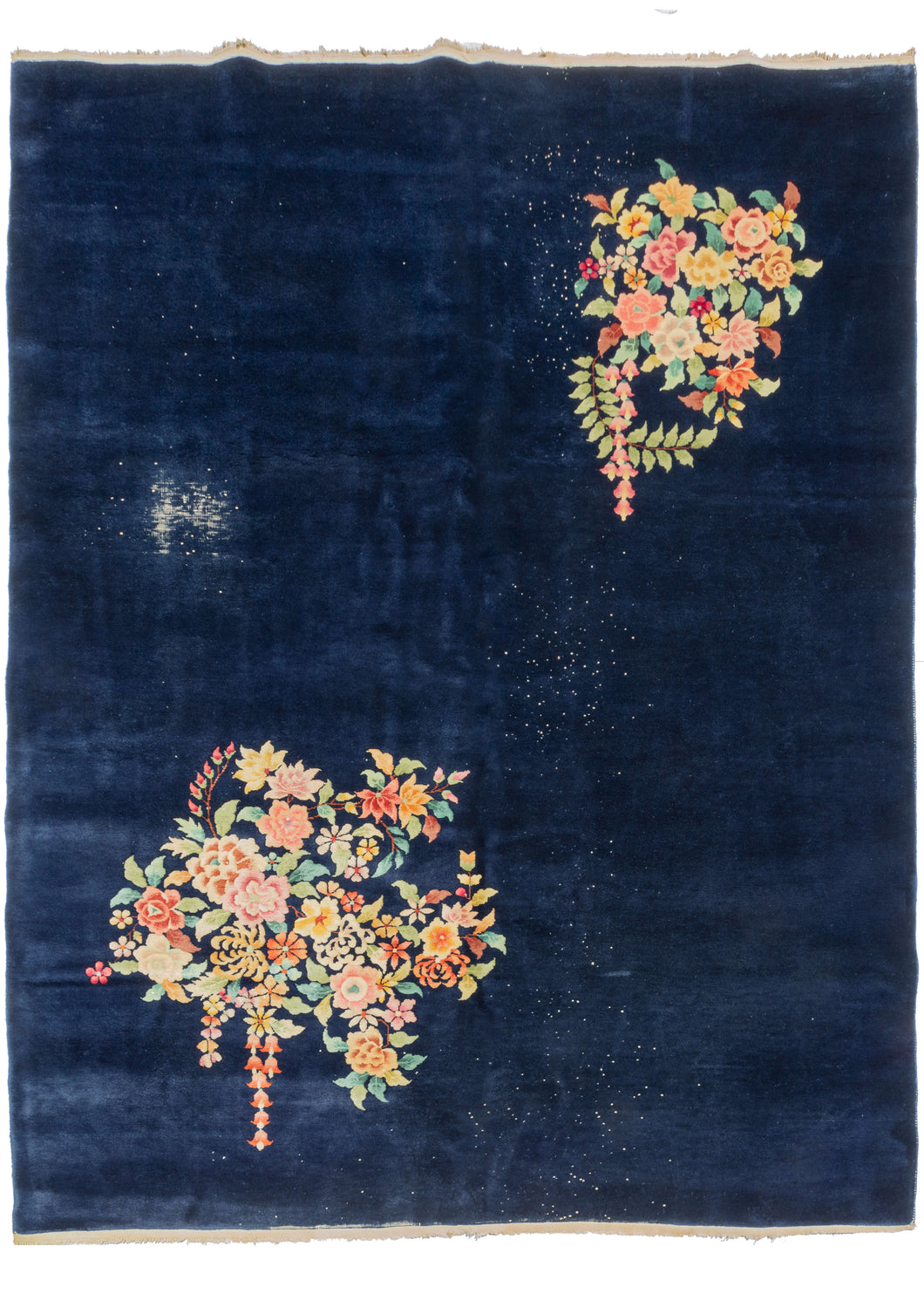 This Deep Blue Chinese Deco Rug  features a sparse and delicate floral design on an immense blue field. The design is open and borderless with two large bouquets that pop against the abyss.  The accenting palette is composed of greens, pinks, browns, and golden yellows. 