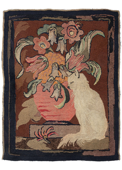 This Vintage Cat Hooked Rug features a whimsical rendering of a white cat sitting in front of a large vase full of flowers. The cat is in profile and the flowers are quite lively in this art nouveau composition.