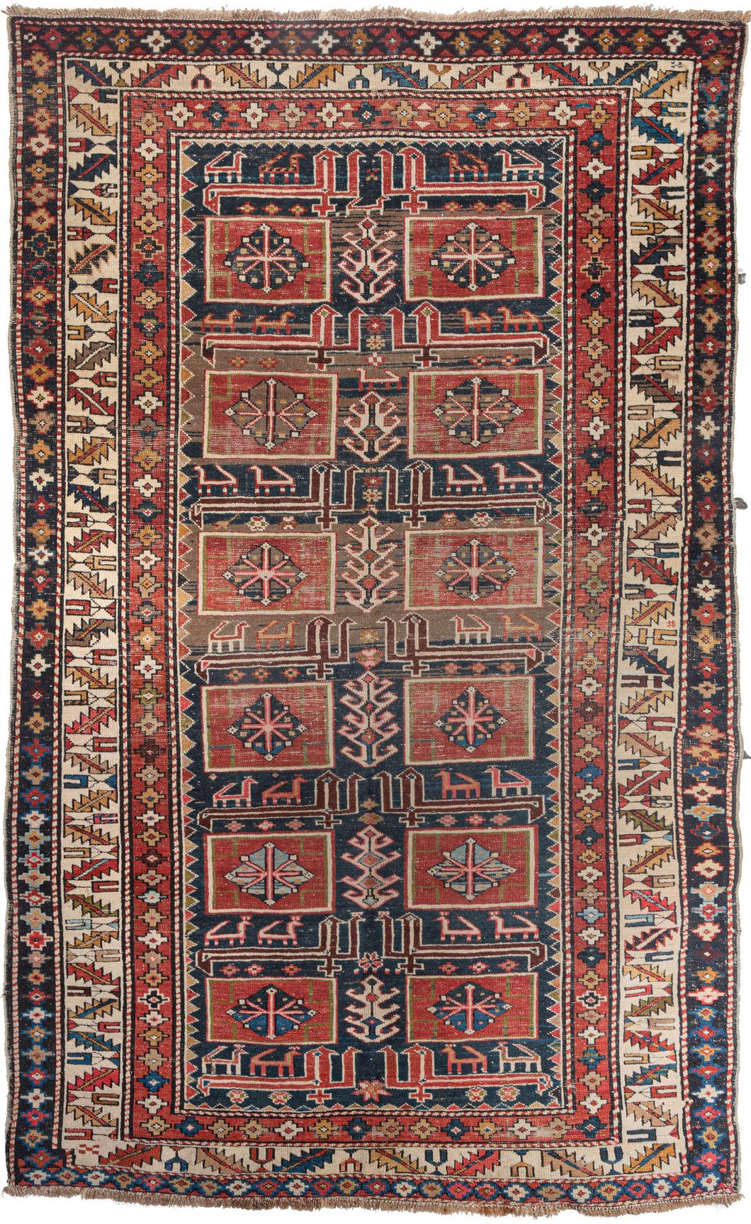 Antique Caucasian area rug featuring a geometric design of small medallions in diagonal columns surrounded by a colorful ivory border. Reds, greens, oranges, and blues are contrasted with cream and brown wool. 
