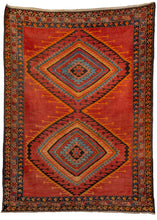 Low pile rug with a red field and multicolored concentric diamond design and floral border, in excellent condition