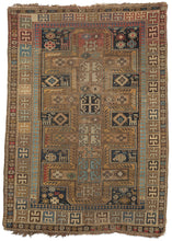 Antique Caucasian Kazak scatter rug featuring a camel colored cross motif on a dark indigo ground. Small animals, protective symbols and geometric designs fill in the space between crosses. The color palette is predominantly gold and camel, light and dark blues with smatterings of red here and there. 