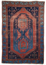 Antique Caucasian rug that features a figure "8" formed by two abstracted vase devices and two "c" shaped motifs with plant like characteristics. The forms are rendered in lacquer red and encapsulated by a cartouche shape in the same tone all on an undulating blue backdrop. In each corner there is a flowering shrub and scattered rosettes on a deep navy ground. Accents of yellow, ivory and various greens add further interest. 