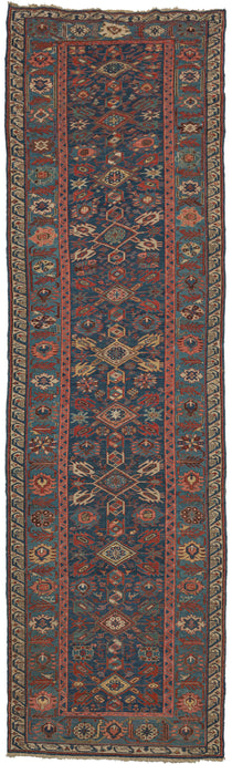 Antique Caucasian soumak runner featuring a repeat geometric pattern in rich jewel tones of reds, pinks, blues, greens, and yellow with accents of ivory and brown. Nicely framed by a wide main border of alternating palmettes and serrated leaves and finished with a minor 