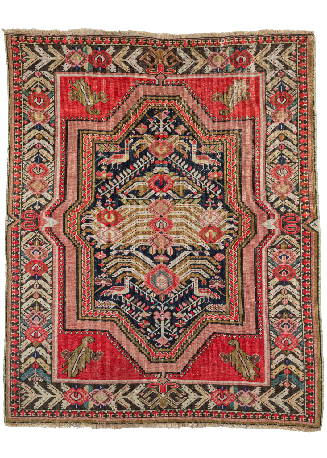Antique Floral Karabagh scatter rug featuring a powerful medallion of angular leaves, rose-inspired palmettes, and a depiction of birds in red, pink, green, brown ivory, and gold on a black ground. Very baroque in feel the medallion crosses over in the border and is flanked by four cornices. Each cornice features a single leaf with a strong personality. The whole is framed by rows of angular leaves broken up by the same pairing of rose palmettes as the field.