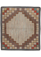 Antique geometric hook rug featuring a bold geometric design, in browns, rust, yellow and green with a central medallion of variegated grey. 