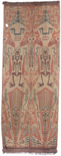 Antique Indonesian Ikat textile constructed in two panels, each with the same motif. Each design features one large person with another person inside among other symbols including lizards, horses and dragons. Atop the head is a hat of skulls with surrounding birds. The hands feature marks similar to stigmata and a crocodile sits atop each shoulder. Prominent near the legs is a large lobster and smaller monkeys.