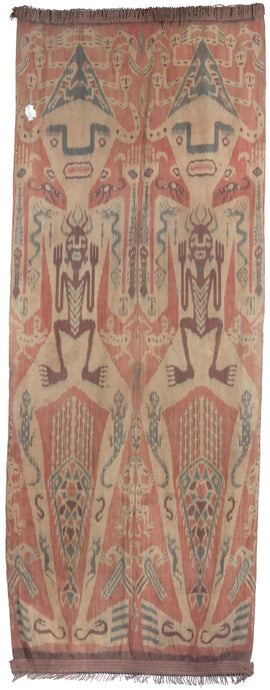 Antique Indonesian Ikat textile constructed in two panels, each with the same motif. Each design features one large person with another person inside among other symbols including lizards, horses and dragons. Atop the head is a hat of skulls with surrounding birds. The hands feature marks similar to stigmata and a crocodile sits atop each shoulder. Prominent near the legs is a large lobster and smaller monkeys.