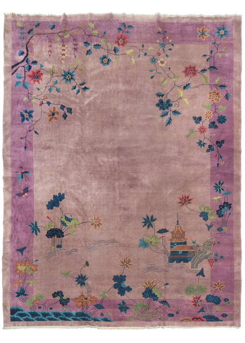 This Whimsical Purple Chinese Deco Rug features a pictorial scene rendered in magenta, pink, green, blue, and golden yellow on a soft lilac field. The design is open with a minimal border of colorful flowers and a pair of fluttering butterflies. It is composed of a water scene with a pagoda amongst flowering plants and a scholar's stone.
