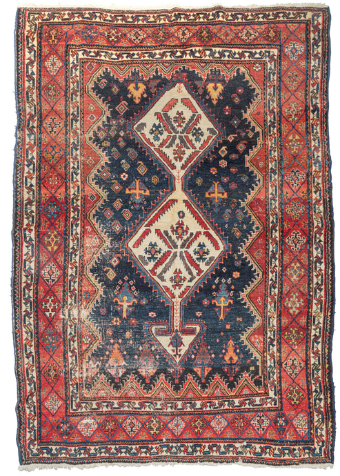 Antique south Persian Lori rug featuring two ivory lozenges topped a directional 