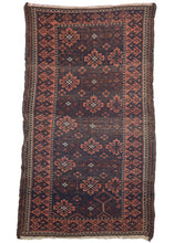 Antique Mina Khani Baluch scatter rug featuring a classic mina khani design and is woven in a simple and straightforward palette of deep reddish brown, navy and brick with small pops of ivory. The main border has a larger scale laleh abbasi or reciprocating pawns border.