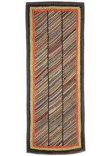 Antique North American hook rug featuring three columns of multicolored diagonal stripes. It's framed by three borders of red/orange, green and black, and the whole is finished with a black binding.