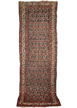 Antique NW Persian Kurdish runner composed of rows of floral boteh on a deep brown ground. The main border features rosettes and jagged leaves on an ivory ground, while the minor borders contain a delicate floral meander. Note the multicolor candy-cane border around the field, which also emphasizes the eccentricity and the wonkiness of the weave itself. 