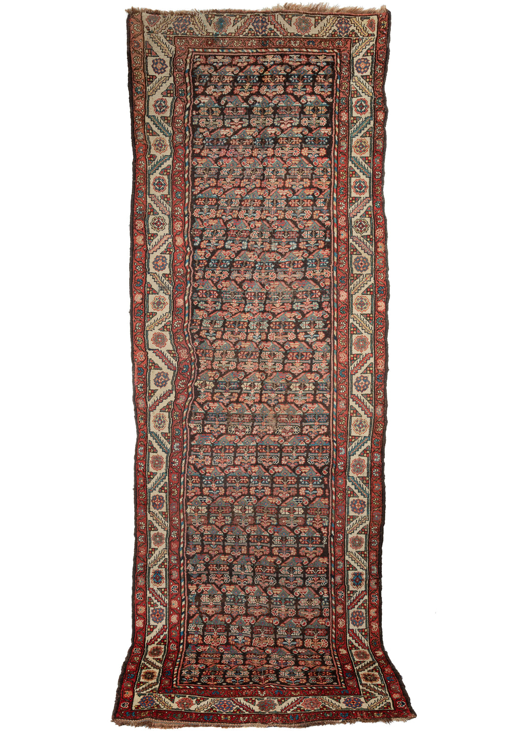 Antique NW Persian Kurdish runner composed of rows of floral boteh on a deep brown ground. The main border features rosettes and jagged leaves on an ivory ground, while the minor borders contain a delicate floral meander. Note the multicolor candy-cane border around the field, which also emphasizes the eccentricity and the wonkiness of the weave itself. 