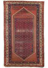 Antique NW Persian Hamadan scatter rug featuring a beautiful double niche lozenge style indigo ground field filled with glowing red geometric flower motifs reminiscent of anchors. Pops of ivory and olive green in the borders and playful flower imagery help brighten up and frame the piece. 