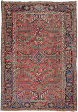 Antique Persian Heriz roomsize rug featuring an allover design of scrolling two-tone leaves in a variety of color combinations such as black and white, turquoise and coral, and green and red on a patinated red ground. All-over designs are less common on Heriz rugs which most often feature large central medallions. The main border is composed of alternating rosettes and serrated leaves in a similar yet distinct fashion to those in the field.