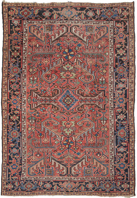 Antique Persian Heriz roomsize rug featuring an allover design of scrolling two-tone leaves in a variety of color combinations such as black and white, turquoise and coral, and green and red on a patinated red ground. All-over designs are less common on Heriz rugs which most often feature large central medallions. The main border is composed of alternating rosettes and serrated leaves in a similar yet distinct fashion to those in the field.