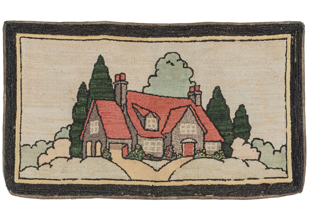 Antique New England hook rug featuring a pictorial design of a red-roofed house with a surrounding landscape. Note the flowering bushes in front of the house. The scene is framed by a thin inner black border and thicker outer black border. 