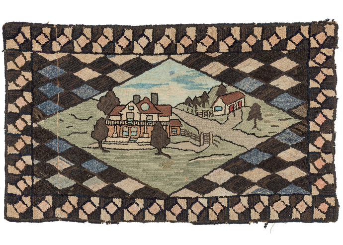 Antique New England hook rug featuring a central diamond depicts a landscape featuring a house framed by a diagonal checkerboard of white, black and blue. Of special note is the beautifully rendered shading in the sky.
