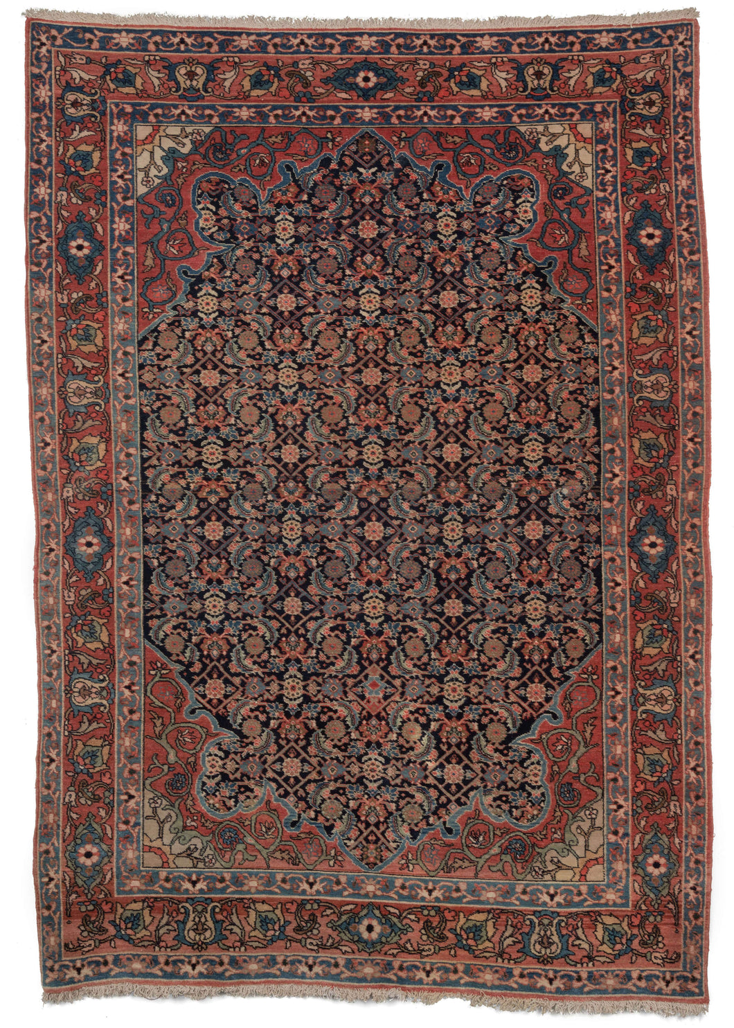 Antique west Persian Farahan Sarouk Area rug featuring an all over Herati design on a deep blue field with soft red and white scalloped cornices. The main border is a detailed scrolling palmette design with the two minor borders a simplified take on the same theme.