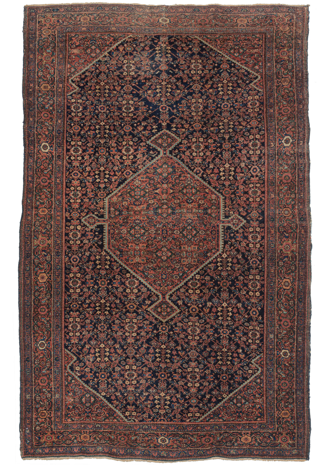 Antique Farahan Rug features a navy ground Herati design field with cornices and a central polygon medallion utilizing a red ground Herati pattern. A fun play of pattern and color that is finely woven and well-executed. The main border is a detailed scrolling palmette design with two minor borders of alternating rosettes.