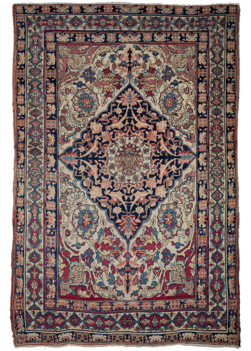 19th Century Lavar Kerman features a central medallion with a curvilinear floral design and scalloped cornices. The field is a rich raspberry color, nicely contrasted by the lighter pinks and creams of the cornices. The minor borders are composed of vine and leaf motifs, while the main border contains alternating blossoms in diamonds and cartouches. 