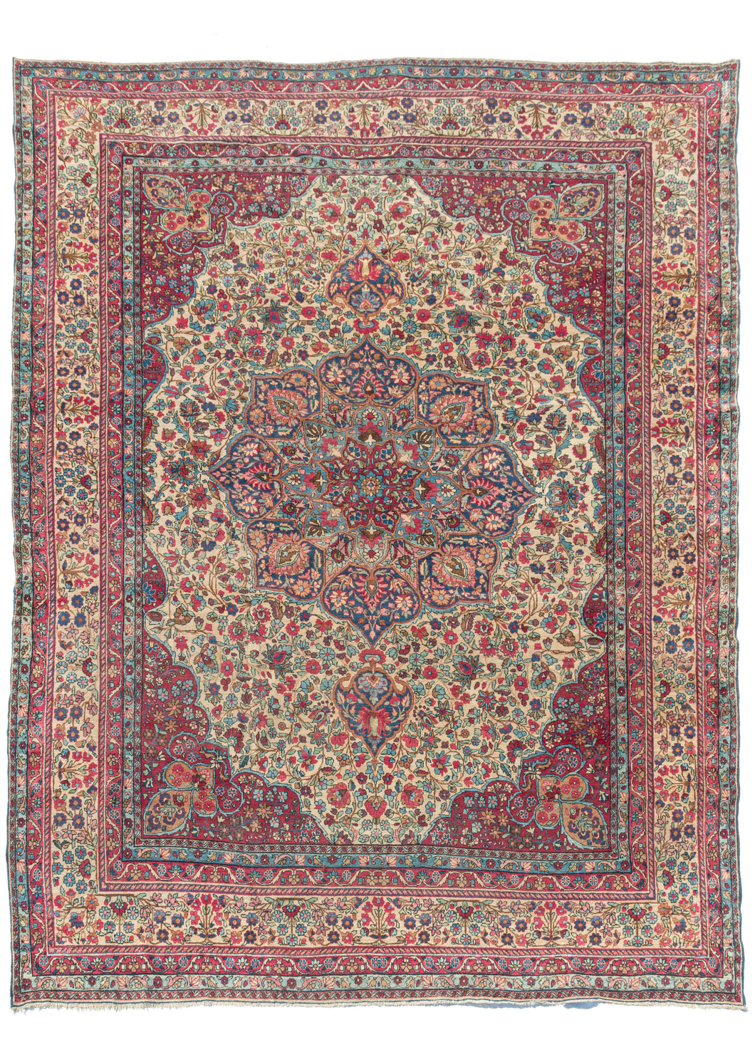 Antique Persian Lavar Kerman room size rug featuring intricate central medallion with a curvilinear floral design and scalloped cornices. The cornices are distinct but have a continuous feel with the large and medallion each with an apricot finial device on a scarlet  rosette filled backdrop. 