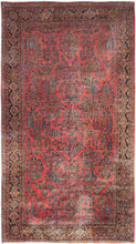 Mohajeran Sarouk was handwoven in Western Iran during the second quarter of the 20th century.   This extra-large rug features a curvilinear floral design of classic floral sprays on a crimson ground. The floral sprays are well-spaced and quite elegant and are placed amongst trees, vases, and even architectural forms. Plush and well-executed these best of type Sarouks are referred to as "Mohajeran". The main border features palmettes inside gold cartouches on a deep navy ground. 