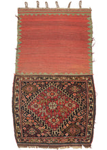 This 19th Century Kashkuli Qashqa'i Bagface features a large latch-hooked diamond medallion filled with a central talish rosette connected to four further rosettes in each direction with various smaller rosettes and protection symbols on brick red ground.  The very full central medallion appears outright spacious next to the deep navy field which surrounds it and is crowded with an abundance of rosettes that appear like flowers growing wild in a lush field.