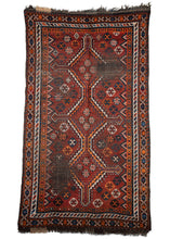 Antique South Persian Shiraz area rug featuring a warm color palette of red and orange with blue and ivory accents on a dark wool warp. Its​ bold geometric design is comprised of three central medallions encapsulated by multiple intricate borders.