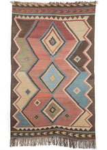 Antique south Persian Qashqa'i area kilim featuring three concentric diamond on an abashed burgundy field and flanked by  asymmetric color blocks. The composition is completed by skirt borders with horizontal movement in different tones and patterning on each end.