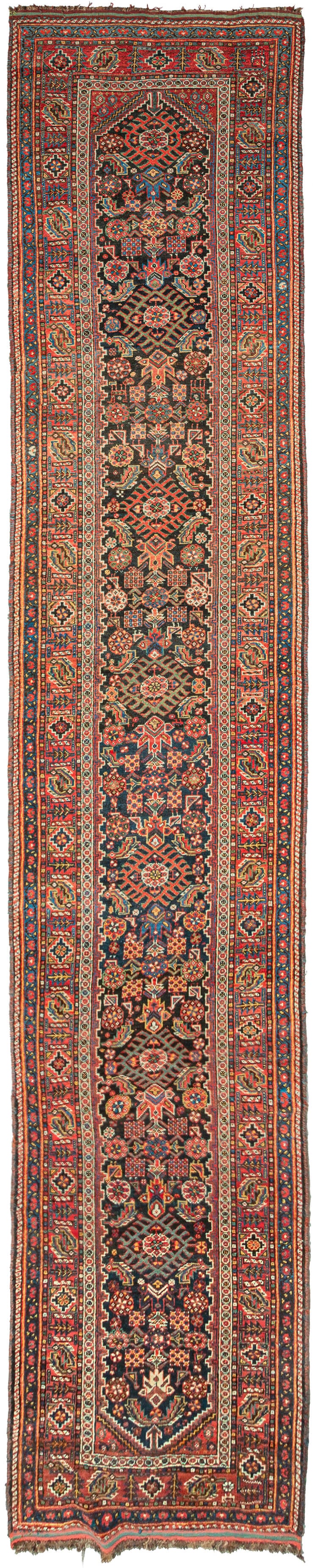 antique South Persian Qashqai runner featuring a large-scale repeat Herati design in various tones of blue, green, red, yellow, and ivory on a dark navy ground. With a main border of stepped octagons and fish-like serrated leaves that are surrounded by multiple minor borders of small boxes, floral meanders, button-like circles, and classic Qashqa'i diagonal stripes. Look closely to see the addition of various stylized birds and the addition of what is likely a dog in a section of the main border
