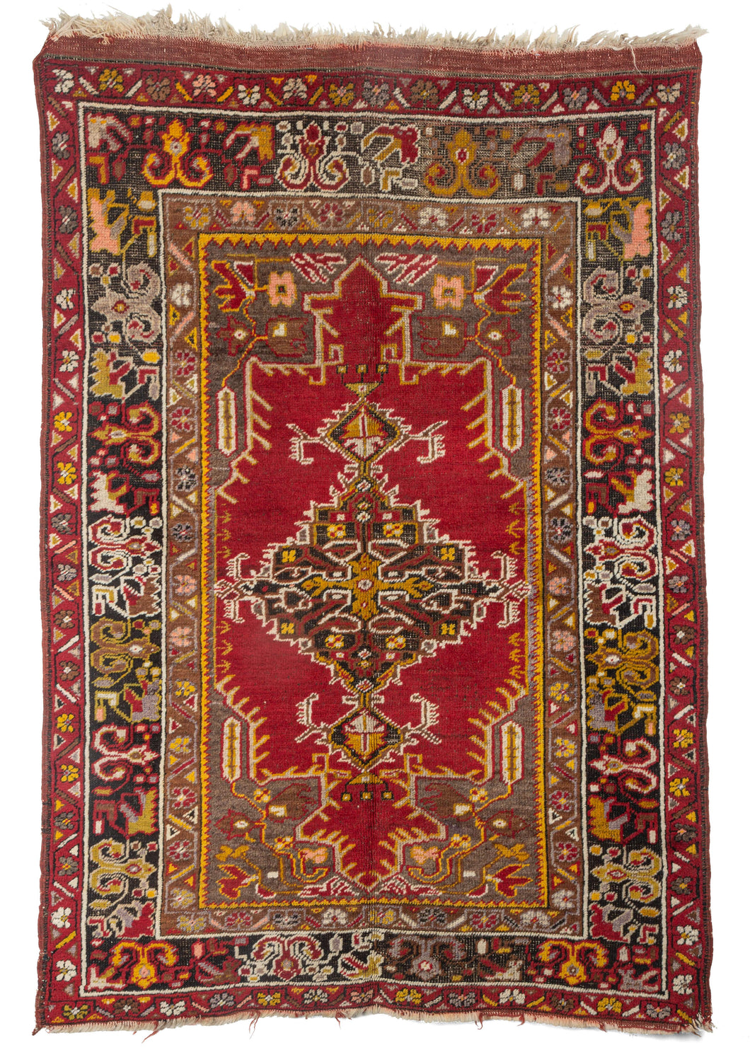 Antique Turkish Maden Scatter rug with  saturated golden and red tonnes atop a grey undyed field 