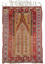 Antique Turkish Obruk Prayer kilim featuring a soft color palette of yellows, reds, and purples with black and white wool used for the details. The design is directional with a large mihrab with an abstract geometric design utilizing diamonds and latch hooks.