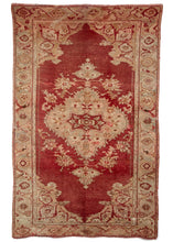Anntique Turkish Oushak with deep red ground and neutral border and details. 19th century and shows its age with many holes and patches