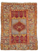 Antique Turkish scatter rug featuring a field broken into three compartments all encapsulated by large main border of abstracted tulips. The central compartment contains a red medallion on a lilac ground and is flanked by two compartments which each contain three tree-like motifs on a red ground. Glowing accents of orange, yellow, and small touches of pink add interest and energy. 