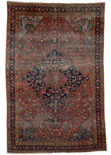 Antique W Persian Farahan Sarouk area rug composed of a inky blue central medallion placed on an earthy terracotta color field. Very dainty and fine curvilinear tendrils and floral vines make up the overall design, and the whole is framed by four scalloped cornices woven in light blue. The border is composed of an equally elegant floral meander featuring an excellent use of rosettes. 