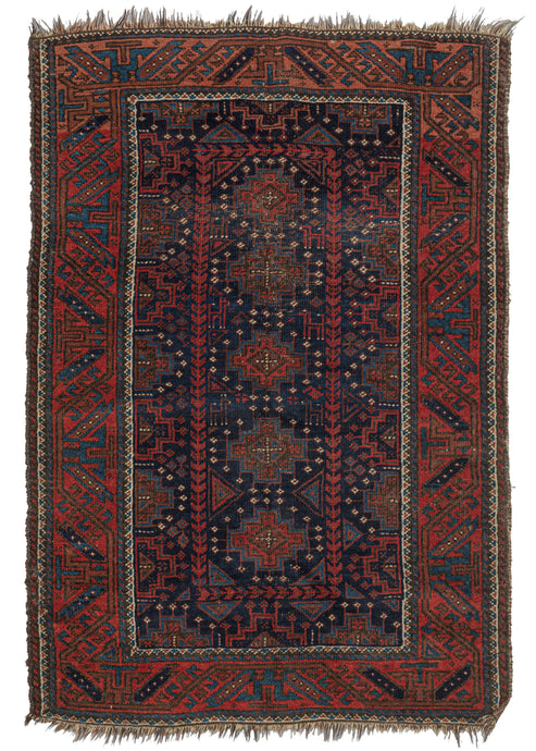 This vibrant Antique Baluch Rug features a central axis of latch-hooked octagons surrounded by triangles, abstracted animals, and a single boteh.  that is encapsulated by an inner border of half octagons. The whole is framed by a large Turkmen line outer border. Nice contrast and tones for a Baluch rug with soft blues, rich lacquer reds, and white details which pops like stars on a clear night against the midnight blue ground.