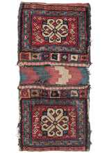This Antique Caucasian Chanteh was constructed in pile weave with a colorful striped flatwoven back. They each feature an ivory Talish rosette on a red ground of little botehs and framed by a red and orange scroll border on a light blue ground.  Each bag face is finished with a lovely top row of colorful concentric squares which are slit open to allow the bag to be tied closed with threads tucked inside.